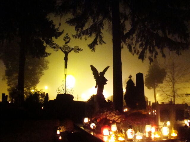 A graveyard lit up with candles