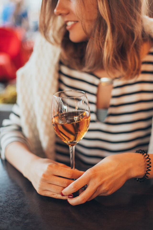 A woman enjoying wine