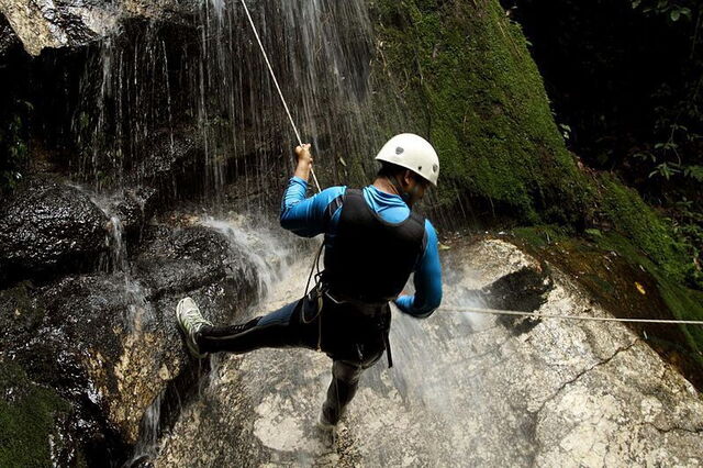 Canyoning  across a waterfall