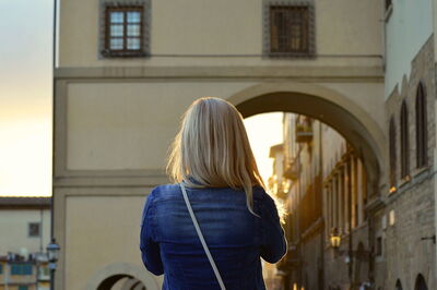 A woman walking around a Tuscan town
