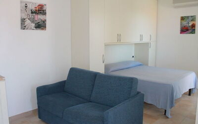 Monolocale con Piccolo Terrazzo 111: Furniture, Room, Property, Floor, Couch, Interior Design, Building, Sofa Bed, Living Room, Comfort