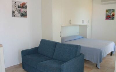 Monolocale con Piccolo Terrazzo 210: Furniture, Room, Property, Floor, Couch, Interior Design, Building, Sofa Bed, Living Room, Comfort