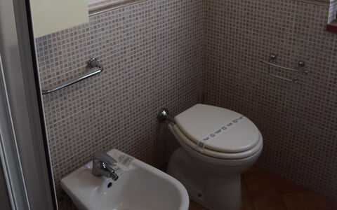 Rocche Di Valiano: Toilet, Bathroom, Toilet Seat, Property, Bathroom Sink, Plumbing Fixture, Tile, Wall, Purple, Floor