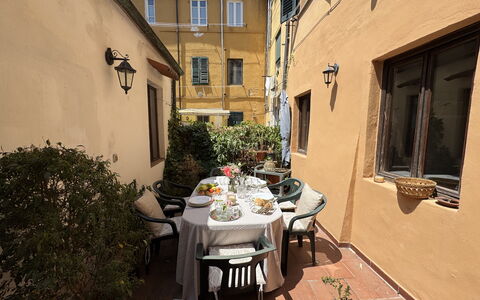 Casina Bella Di Lucca: Furniture, Door, Flowerpot, Houseplant, Chair, Outdoor Table, Outdoor Furniture, Balcony, Kitchen & Dining Room Table, Courtyard