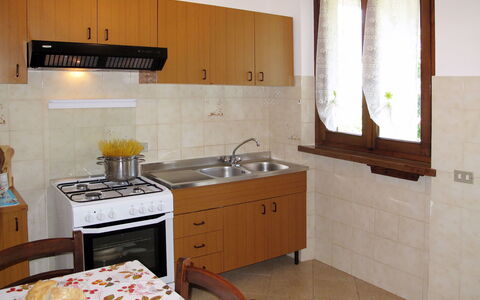 Emilia: Kitchen, Furniture, Wood, Kitchen Appliance, Flooring, Major Appliance, Countertop, Interior Design, Floor, Kitchen Sink