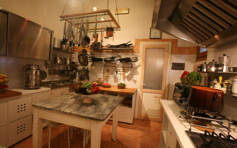 Villa Toppani Del Sodo: Countertop, Cabinetry, Table, Furniture, Kitchen, Kitchen Appliance, Lighting, Kitchen Stove, Wood, Interior Design