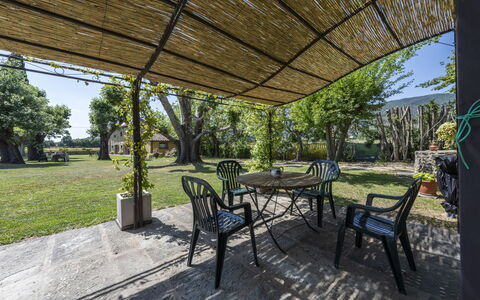 Villa Chio: Plant, Property, Table, Shade, Botany, Tree, Building, Chair, Outdoor Furniture, Architecture