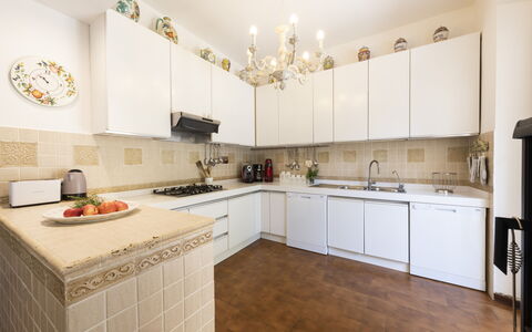 Villa Monteresi: Cabinetry, Countertop, Property, Sink, Kitchen, Wood, Kitchen Stove, Lighting, Interior Design, Flooring