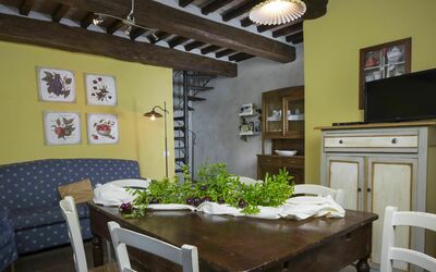 Fienile Holiday Home: Table, Furniture, Cabinetry, Countertop, Picture Frame, Building, Chair, Plant, Interior Design, Drawer