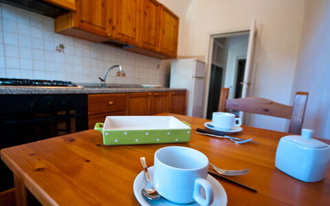 Holiday Home Giannella: Table, Tableware, Property, Cabinetry, Furniture, Drinkware, Dishware, Coffee Cup, Cup, Wood