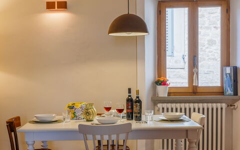 Appartamento Mancini: Property, Furniture, Table, Window, Lighting, Interior Design, Wood, Shelving, Living Room, Wall