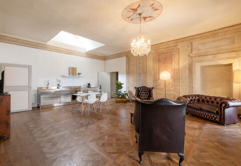 Appartamento Reale: Table, Furniture, Wood, Lighting, Hall, Interior Design, Building, Cabinetry, Flooring, Floor