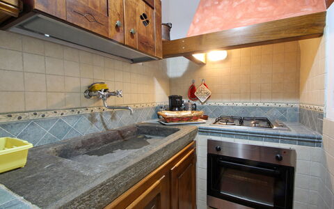 Casa Luigi: Countertop, Cabinetry, Property, Tap, Kitchen Stove, Kitchen, Kitchen Appliance, Wood, Gas Stove, Plumbing Fixture