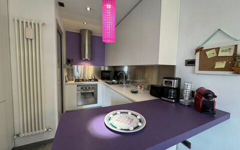 Galleria Degli Artisti: Property, Furniture, Cabinetry, Table, Purple, Interior Design, Lighting, Countertop, Wood, Floor
