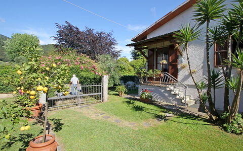 Casa Il Prato: Plant, Sky, Building, Flowerpot, Cloud, Tree, Vegetation, Cottage, Grass, Landscape