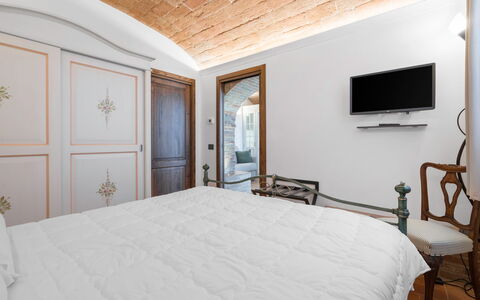 Le Volte, Borgo Campassini, Monteriggioni: Bedroom, Furniture, Interior Design, Bed, Wall, Bed Sheet, Bedding, Ceiling, Bed Frame, Lighting