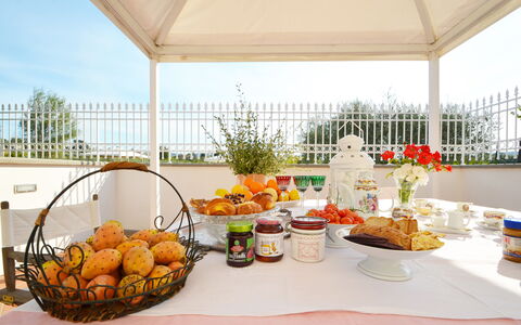 Villa Yvonne: Furniture, Table, Food, Chair, Linens, Breakfast, Serveware, Kitchen & Dining Room Table, Tablecloth