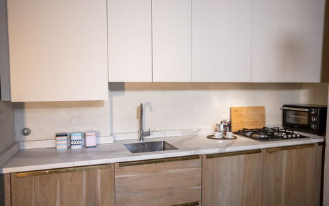 Stylish Apartment: Kitchen, Countertop, Wood, Kitchen Appliance, Interior Design, Cabinetry, Flooring, Major Appliance, Kitchen Sink, Home Appliance