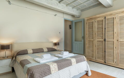 San Cristofano Blu Apartment Santa Croce, Florence: Furniture, Interior Design, Bed, Bedroom, Floor, Flooring, Wood, Ceiling, Room, Bedding