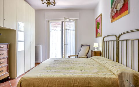 Il Ferrone Apartment with Garden - Greve in Chiant: Bed, Bedroom, Bedding, Furniture, Interior Design, Bed Sheet, Room, Wood, Flooring, Floor