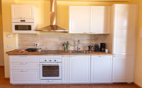 Marina's Lodge: Kitchen, Cabinetry, Countertop, Kitchen Appliance, Flooring, Wood, Interior Design, Major Appliance, Furniture, Floor