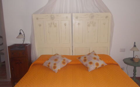 Appartamento Girasole Seaside and Pool: Bed, Furniture, Bedroom, Bedding, Bed Sheet, Wood, Linens, Interior Design, Yellow, Floor