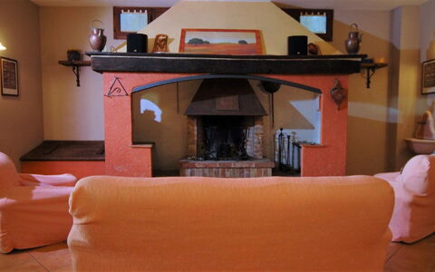 Terre di Giano Private Pool and View, Umbria: Furniture, Interior Design, Flooring, Floor, Room, Hearth, Lighting, Ceiling, Living Room, Chair