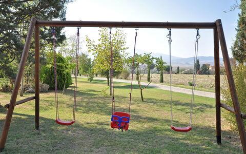 Villa Cassia: Swing, Outdoor Play Equipment, Playground, Public Space, Grass, Tree, Shade, Architecture, Recreation, Play